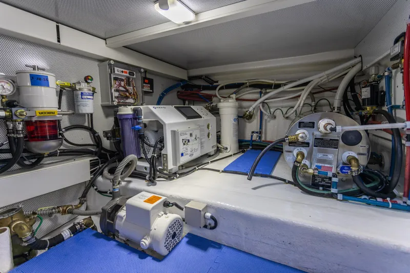 Boondoggle Yacht Photos Pics Engine room of 2021 North Pacific 49 Pilothouse with mechanical equipment and wiring.