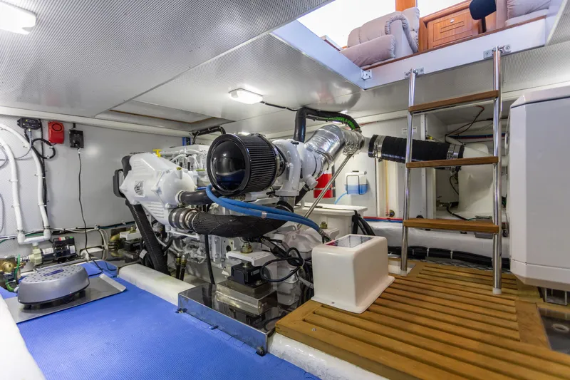 Boondoggle Yacht Photos Pics Engine room of 2021 North Pacific 49 Pilothouse yacht, featuring modern equipment and ladder access.