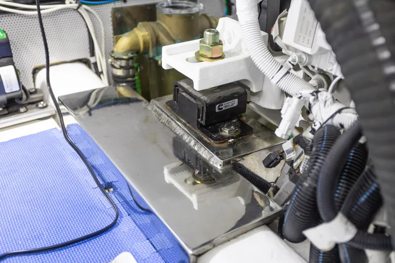 Boondoggle Yacht Photos Pics Engine room of 2021 North Pacific 49 Pilothouse with mechanical components and wiring.