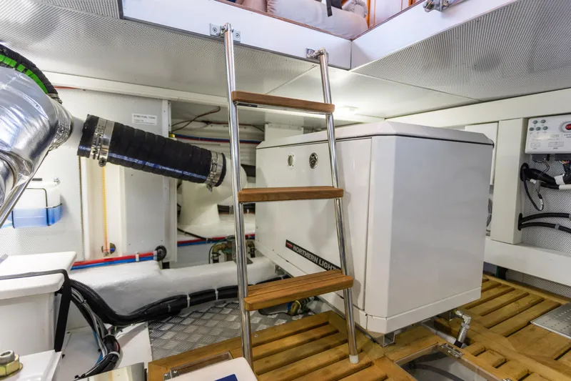 Boondoggle Yacht Photos Pics Engine room of 2021 North Pacific 49 Pilothouse yacht with ladder and equipment.