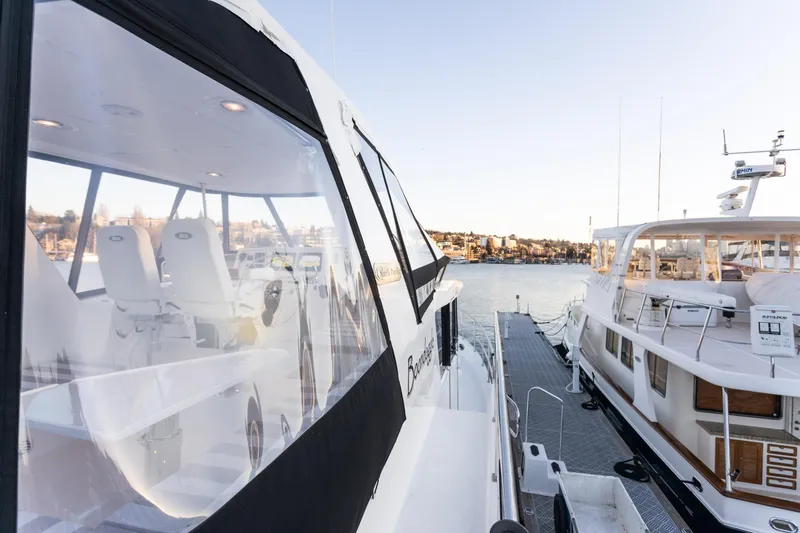 Boondoggle Yacht Photos Pics 2021 North Pacific 49 Pilothouse yacht docked, showcasing sleek design and spacious interior.