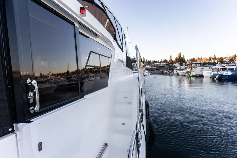 Boondoggle Yacht Photos Pics 2021 North Pacific 49 Pilothouse yacht docked in a serene marina setting.