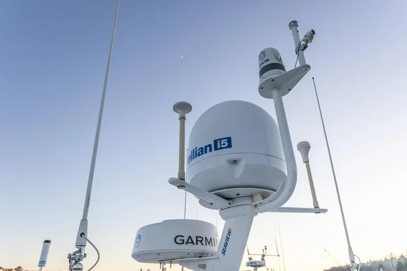 Boondoggle Yacht Photos Pics Satellite and radar equipment on 2021 North Pacific 49 Pilothouse boat under clear sky.