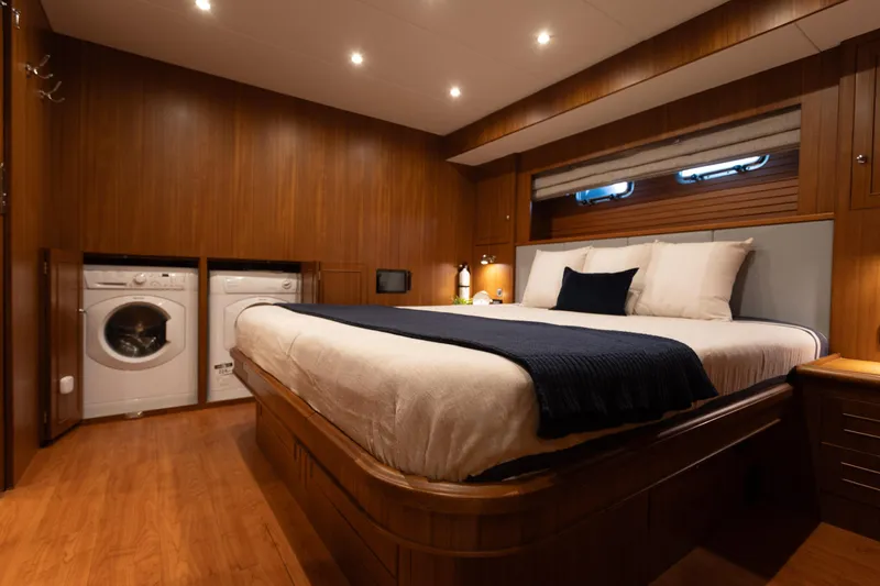 Boondoggle Yacht Photos Pics Luxurious bedroom in 2021 North Pacific 49 Pilothouse yacht with washer and dryer.