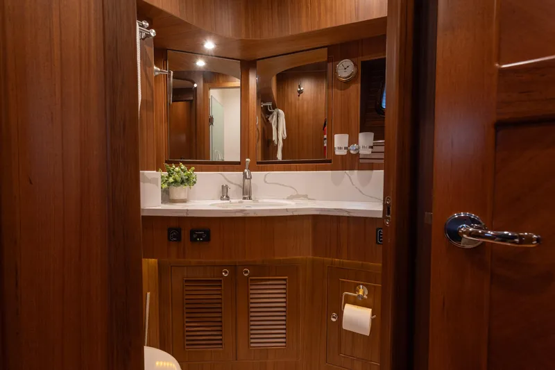 Boondoggle Yacht Photos Pics Luxurious bathroom interior of 2021 North Pacific 49 Pilothouse yacht with wooden finish.