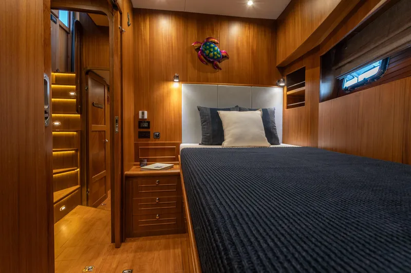 Boondoggle Yacht Photos Pics Luxurious cabin interior of 2021 North Pacific 49 Pilothouse yacht with wooden finish.