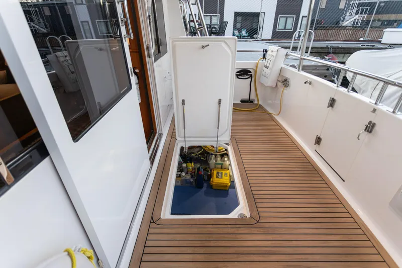 Boondoggle Yacht Photos Pics North Pacific 49 Pilothouse 2021 yacht deck with open hatch revealing engine compartment.