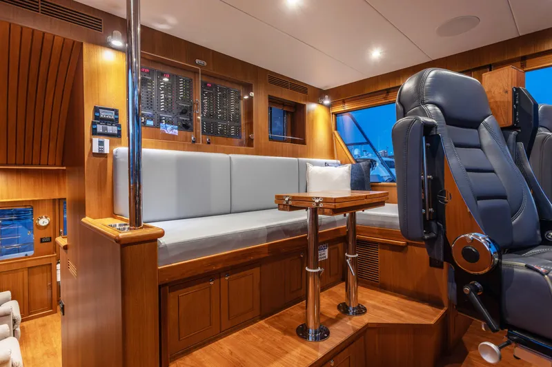Boondoggle Yacht Photos Pics Luxurious interior of 2021 North Pacific 49 Pilothouse with plush seating and control panel.