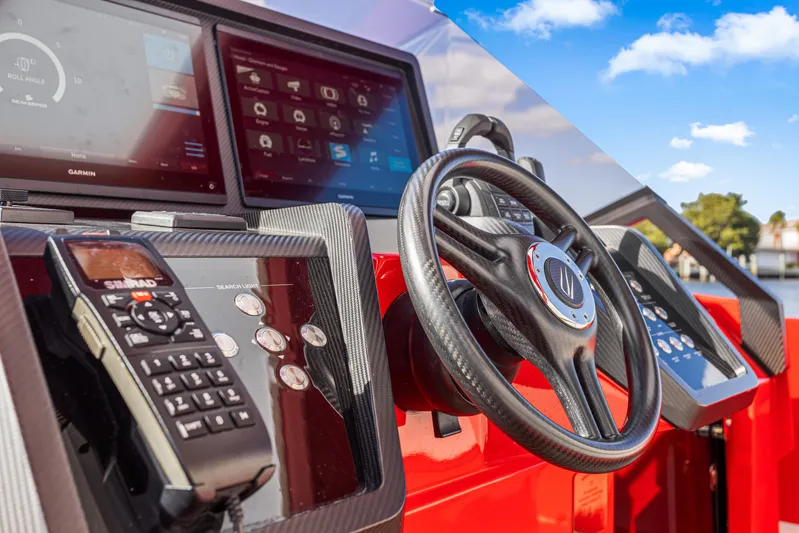 Corso Red Yacht Photos Pics Steering wheel and control panel of 2021 Wally 48 boat with navigation screens.