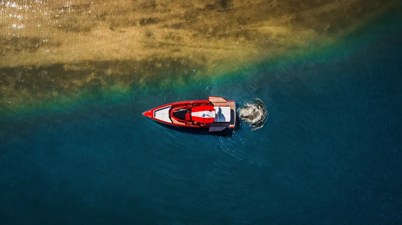 Corso Red Yacht Photos Pics Aerial view of 2021 Wally 48 boat navigating clear blue waters.