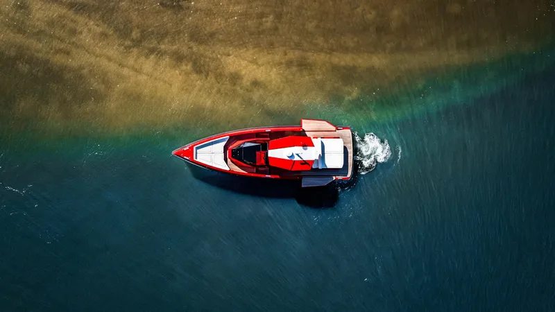 Corso Red Yacht Photos Pics Aerial view of a 2021 Wally 48 boat cruising in clear blue water.