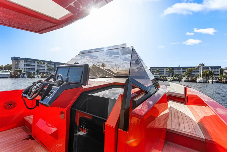 Corso Red Yacht Photos Pics Red 2021 Wally 48 yacht with modern cockpit, docked near waterfront buildings.