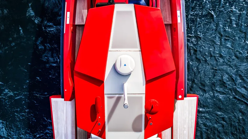 Corso Red Yacht Photos Pics Top view of a 2021 Wally 48 yacht with vibrant red design on water.