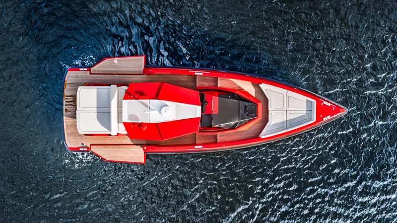 Corso Red Yacht Photos Pics Aerial view of 2021 Wally 48 yacht with sleek red design on water.