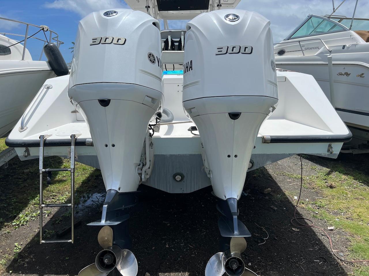 2004 Venture 34 Center Console with twin Yamaha 300 engines, docked outdoors.