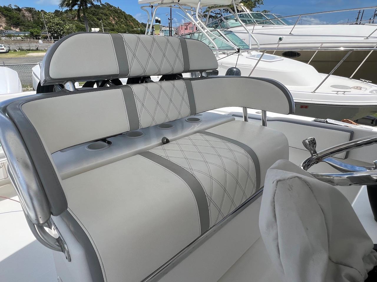 2004 Venture 34 Center Console boat seating with elegant gray and white upholstery.