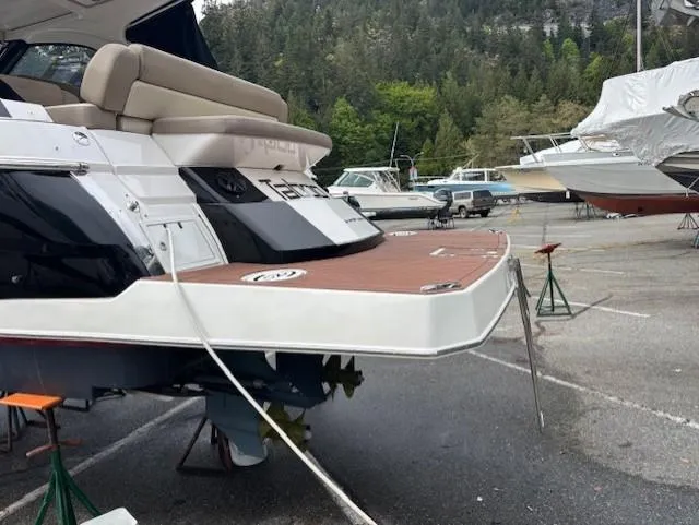 Taboo Yacht Photos Pics 2013 Regal 35 Sport Coupe on dry dock, showcasing rear deck and seating area.