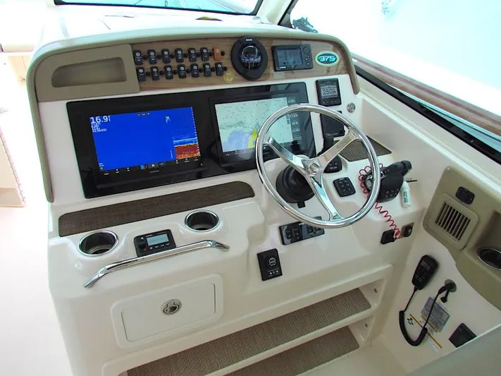  Yacht Photos Pics 2014 Grady-White Freedom 375 boat dashboard with steering wheel and navigation screens.