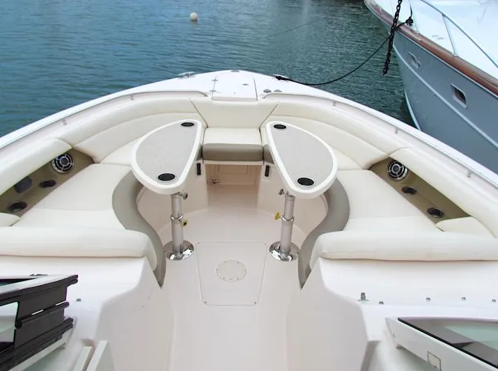  Yacht Photos Pics 2014 Grady-White Freedom 375 boat interior with seating and tables, docked on calm water.