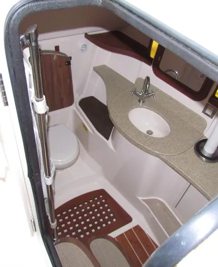 Yacht Photos Pics 2014 Grady-White Freedom 375 boat bathroom with sink, toilet, and wooden accents.