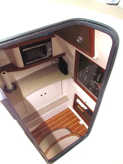  Yacht Photos Pics 2014 Grady-White Freedom 375 cabin interior with microwave and wood flooring.