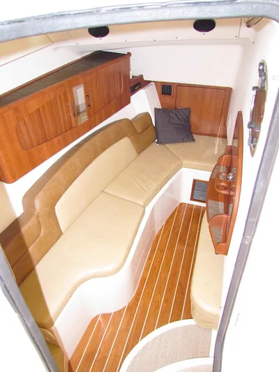  Yacht Photos Pics 2014 Grady-White Freedom 375 cabin interior with wood accents and beige seating.