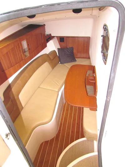 Yacht Photos Pics 2014 Grady-White Freedom 375 cabin interior with wood accents and beige seating.