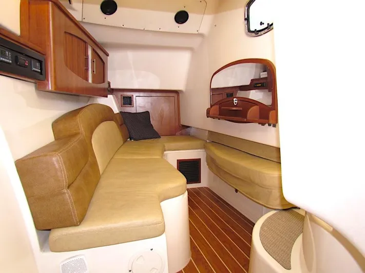  Yacht Photos Pics 2014 Grady-White Freedom 375 cabin interior with beige seating and wooden accents.