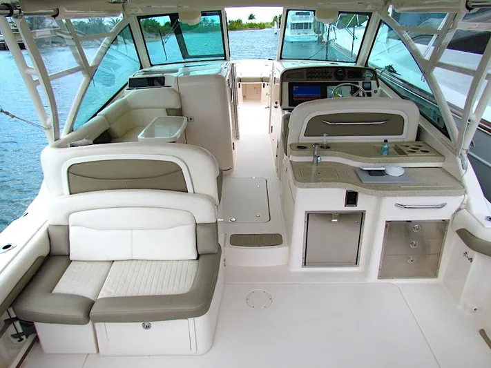  Yacht Photos Pics 2014 Grady-White Freedom 375 boat interior with seating and helm, docked on water.