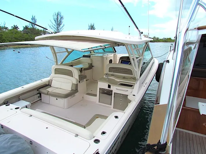  Yacht Photos Pics 2014 Grady-White Freedom 375 boat docked on calm water.