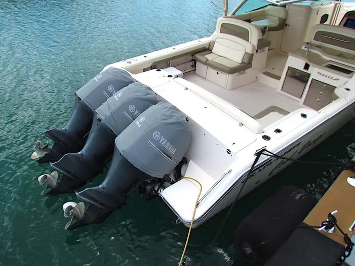  Yacht Photos Pics 2014 Grady-White Freedom 375 boat with triple Yamaha outboard engines on clear water.