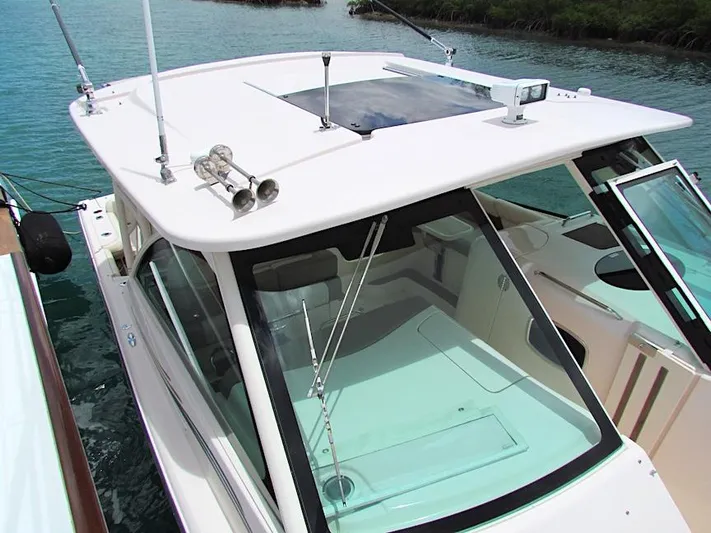  Yacht Photos Pics 2014 Grady-White Freedom 375 boat docked on clear water.