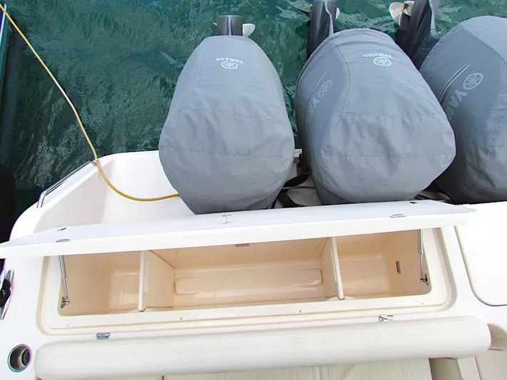  Yacht Photos Pics 2014 Grady-White Freedom 375 boat with covered outboard motors and open storage compartment.