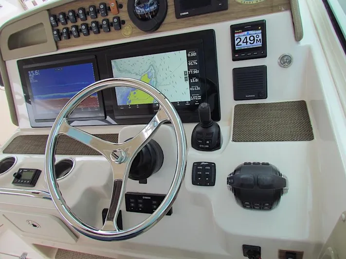  Yacht Photos Pics 2014 Grady-White Freedom 375 helm with steering wheel, navigation screens, and control panel.