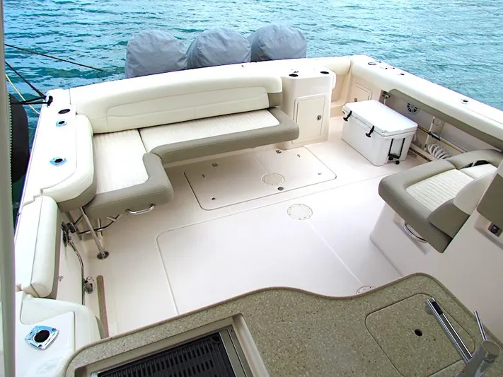  Yacht Photos Pics 2014 Grady-White Freedom 375 boat interior with seating and storage, docked on calm water.