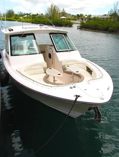  Yacht Photos Pics 2014 Grady-White Freedom 375 boat docked on a serene waterway.