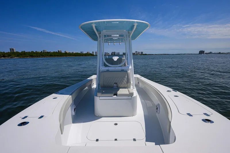  Yacht Photos Pics 2024 Conch 25 boat on calm water, clear sky, and distant shoreline.