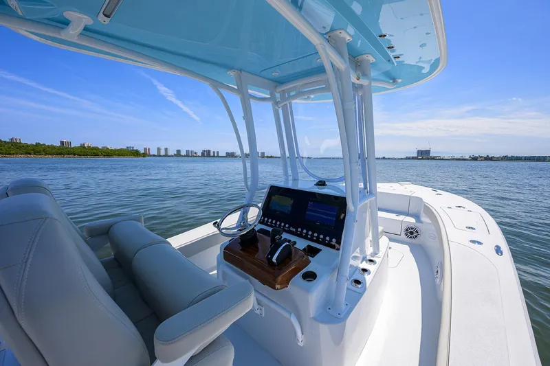  Yacht Photos Pics 2024 Conch 25 boat interior with modern console on calm water.
