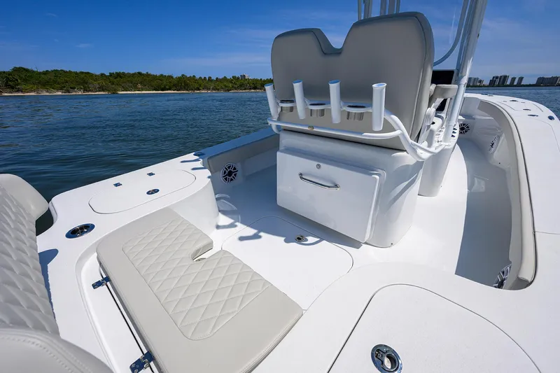  Yacht Photos Pics 2024 Conch 25 boat interior with seating and rod holders on a sunny day.