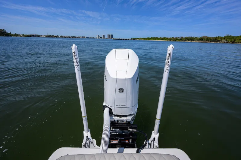  Yacht Photos Pics 2024 Conch 25 boat on water, rear view with motor and clear sky.
