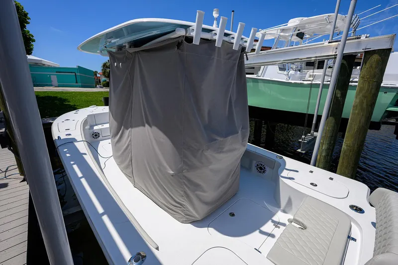  Yacht Photos Pics 2024 Conch 25 boat with covered center console, docked under clear blue sky.