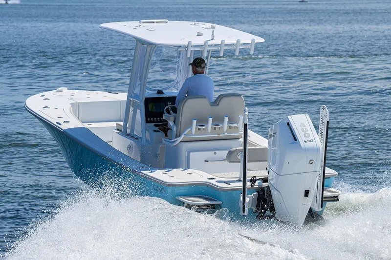  Yacht Photos Pics 2024 Conch 25 boat cruising on open water, rear view.
