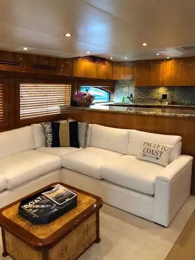  Yacht Photos Pics Luxurious interior of a 2007 Hatteras 68 Convertible yacht with white sofa and wooden accents.