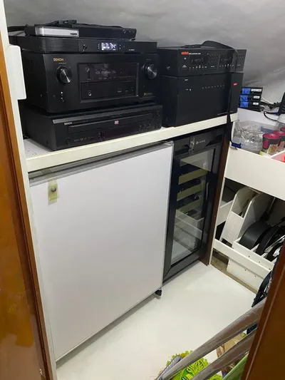  Yacht Photos Pics 2007 Hatteras 68 Convertible yacht interior with audio equipment and mini fridge.