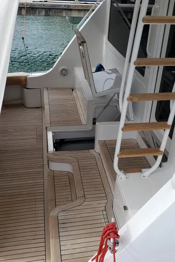  Yacht Photos Pics 2007 Hatteras 68 Convertible yacht with teak deck and ladder to upper level.