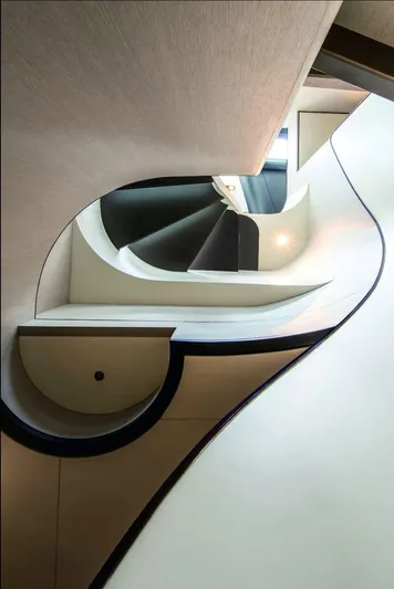 Miss M Yacht Photos Pics Elegant spiral staircase inside 2020 Azimut Grande 35 Metri yacht, showcasing modern design.