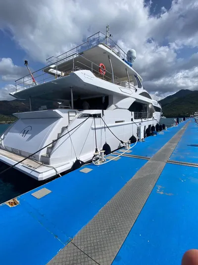 Miss M Yacht Photos Pics Azimut Grande 35 Metri yacht docked, 2020 model, with blue sky and mountains in the background.