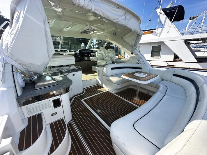 Rogue Yacht Photos Pics Luxurious 2006 Sea Ray 48 Sundancer yacht interior with elegant seating and wood flooring.