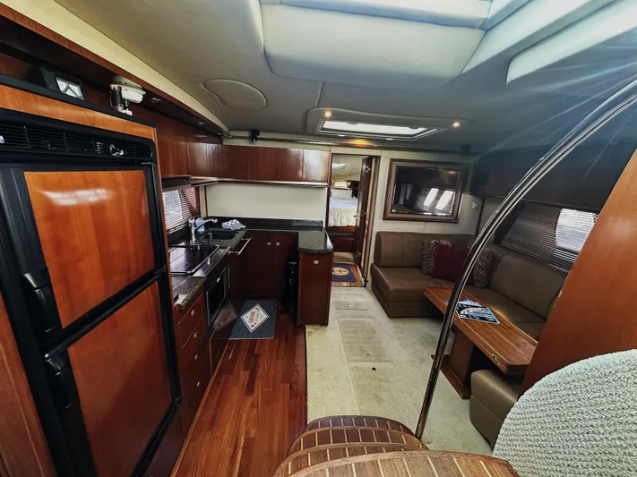 Rogue Yacht Photos Pics Interior of 2006 Sea Ray 48 Sundancer yacht with modern kitchen and seating area.