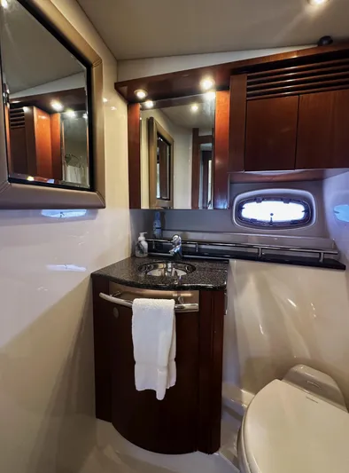Rogue Yacht Photos Pics Luxurious bathroom interior of 2006 Sea Ray 48 Sundancer yacht with elegant wood cabinetry.